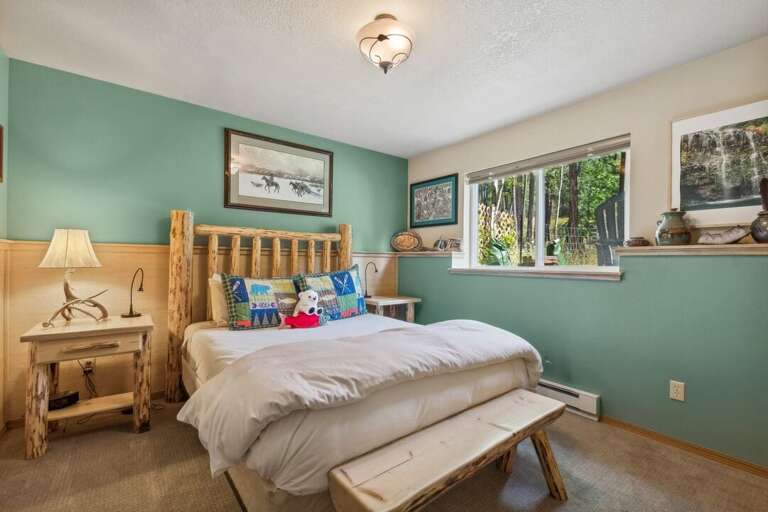 Queen-size bed with a rustic log-frame bed. | Lower Level