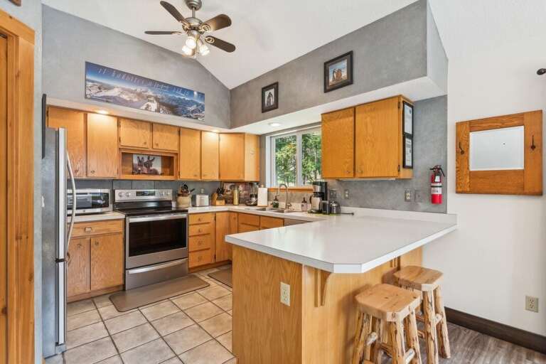 A warm and inviting kitchen with natural wood finishes and modern appliances. | Upper Level
