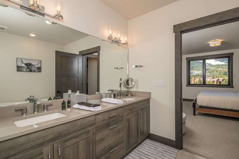 Ensuite bathroom with dual vanity sinks for your convenience. | Main Level