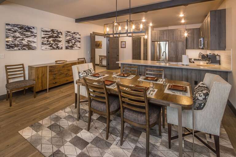 An open-concept dining area featuring wood accents, modern lighting, and a spacious layout perfect for gathering and entertaining. | Main level