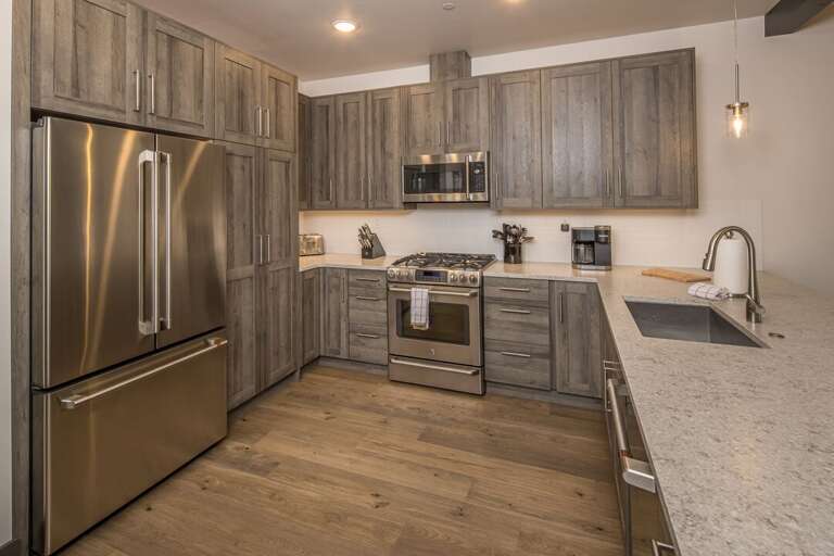 The open kitchen with lots of room allows for easy cooking while on the ski trip of your dreams! | Main level
