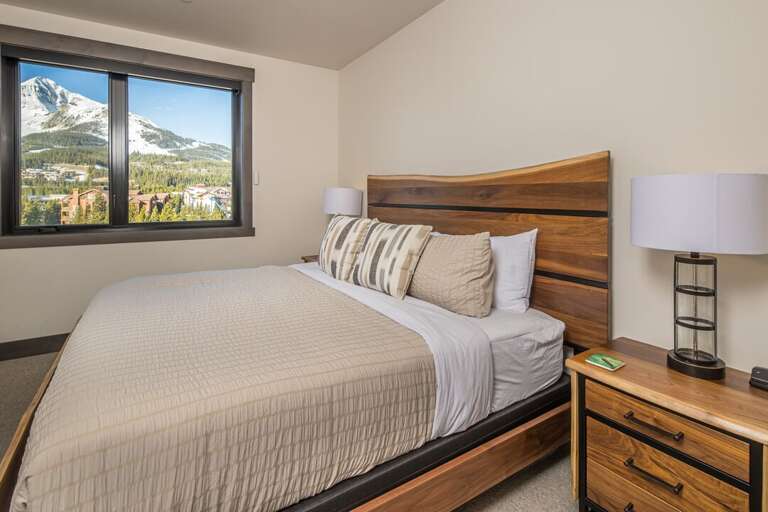 Primary bedroom with a king bed and great views of Lone Peak. | Main Level