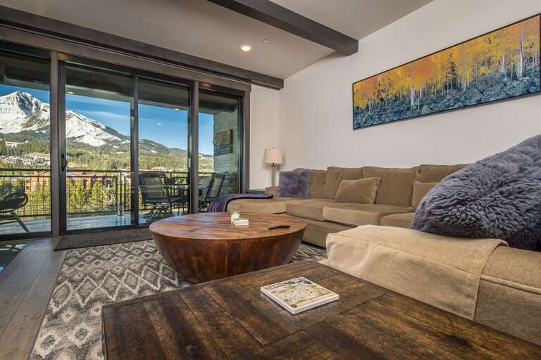 Relax on the couch or enjoy your morning cup of coffee on the deck. | Main Level