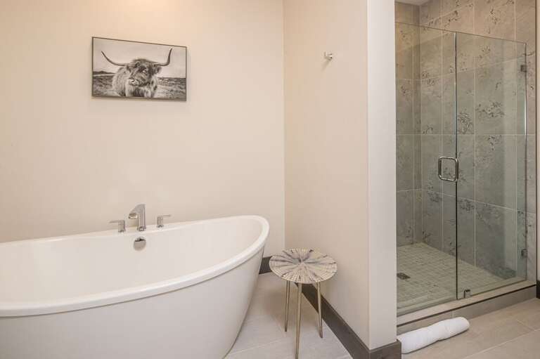 A walk-in shower and lovely tub for ultimate relaxation. | Main Level