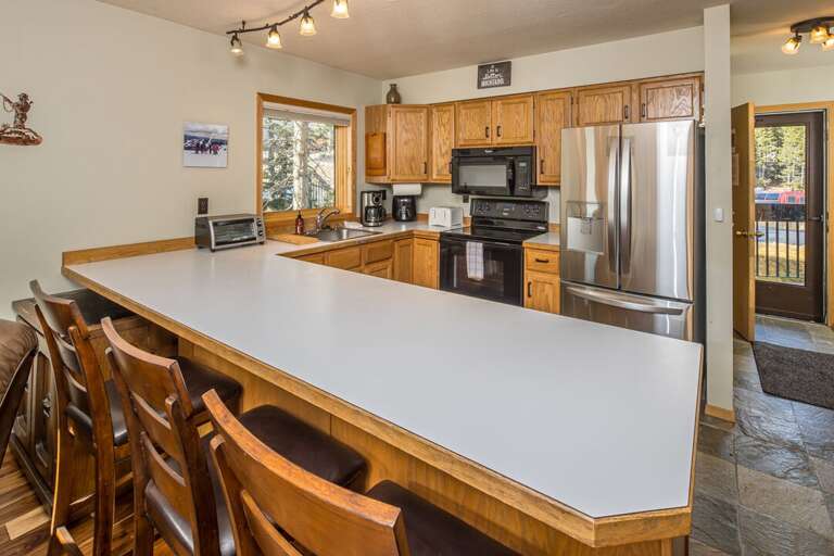 Bar seating for three to have a quick snack and keep the chef some company | Main Level