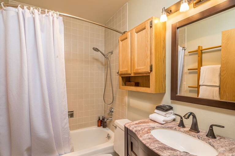Tub/shower combo with single vanity in secondary bathroom | Main Level