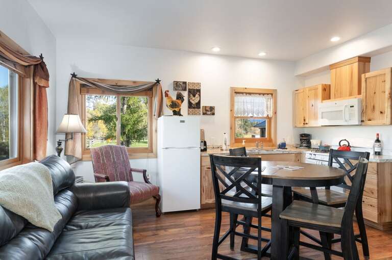 Enjoy seating for the whole family with the nice leather sofa and high top table. | Main Level | Northern Lights