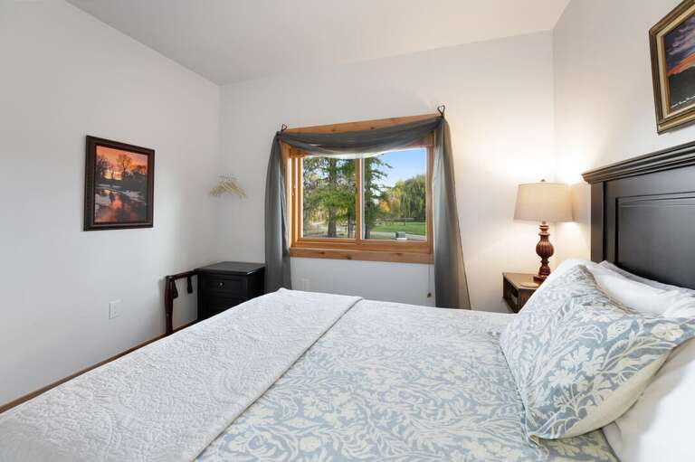 Enjoy views of the neighboring forest out your bedroom window. | Main Level | Northern Lights