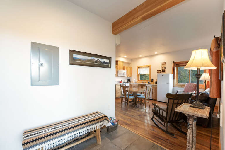 An entryway that opens into a cozy living and kitchen area. | Main Level | Southern Cross
