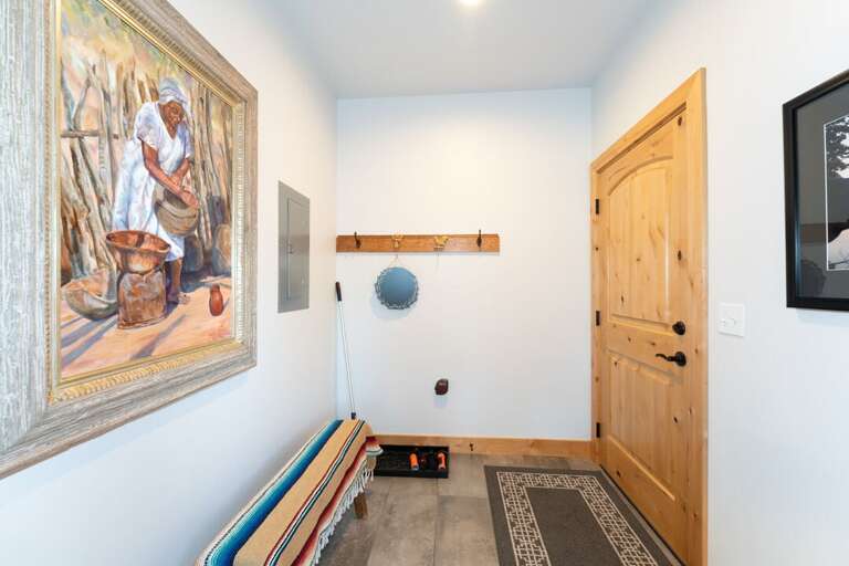 A warm and welcoming entryway featuring a colorful bench, perfect for kicking your boots off. | Main Level | Northern Lights