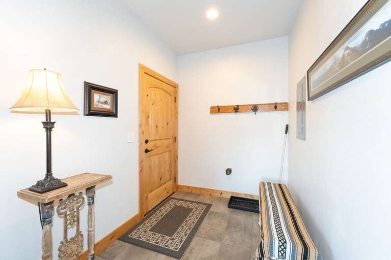 Entryway with a spot to hang your coat and rest your boots. | Main Level