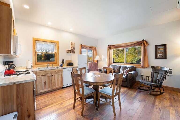 Seating for four at the dining table and the living room. | Main Level