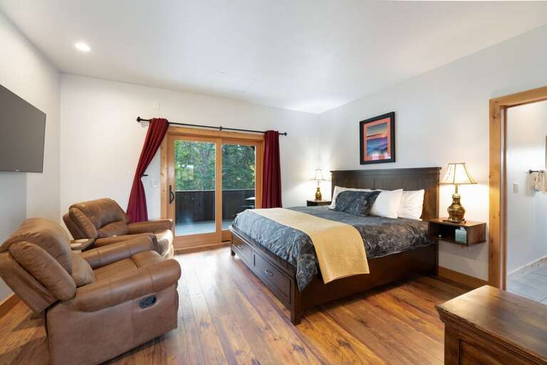 Relax on the comfortable recliners and enjoy the natural light through the large sliding doors. | Upper Level