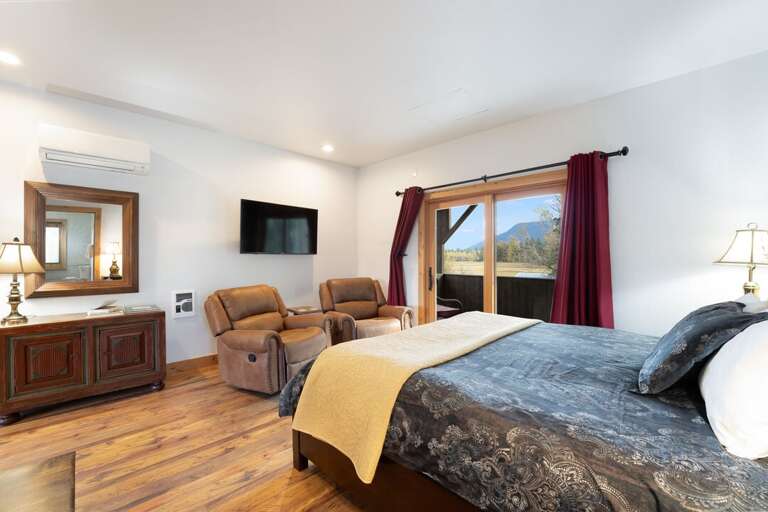 Relax in the king-size bed and take in the breathtaking views from the slider. | Upper Level