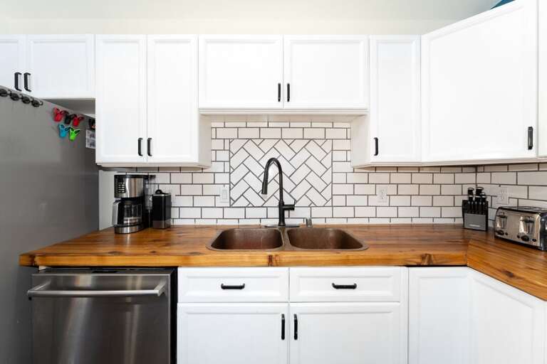 Kitchen featuring dishwasher and double sink.