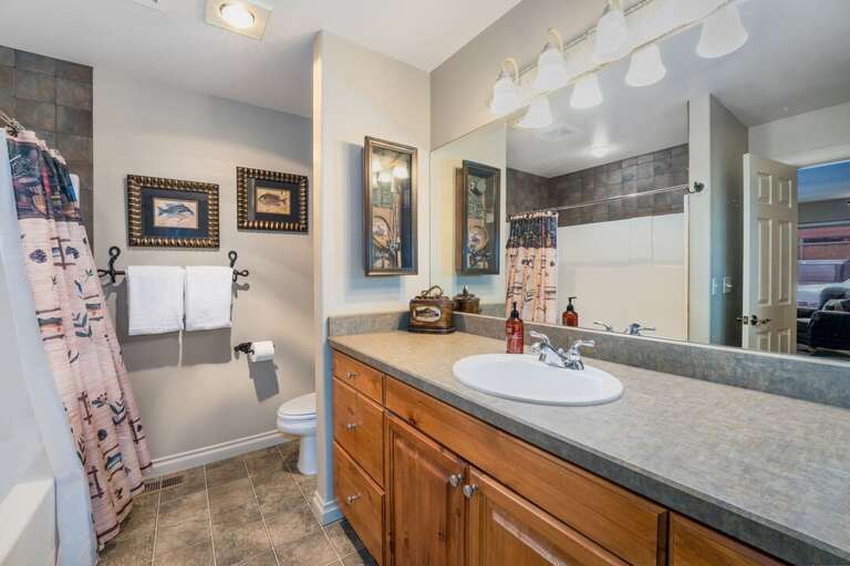 Ensuite bathroom with single vanity sink.
