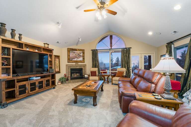 Main living room with large window and entertainment area.