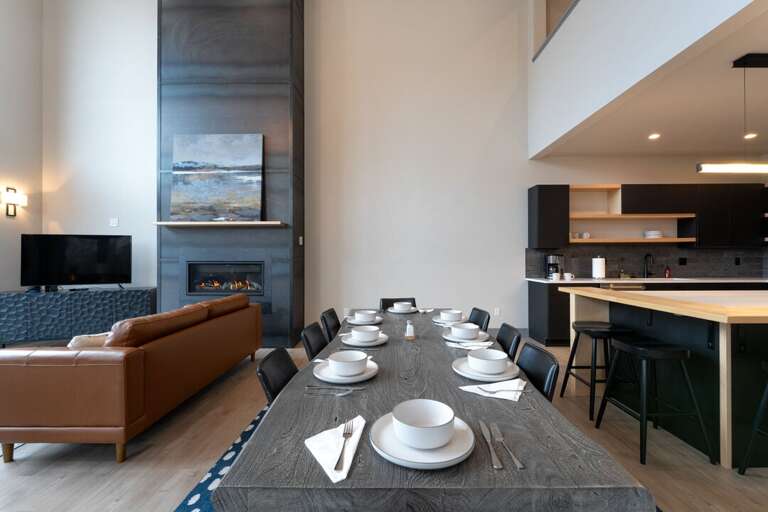 Dining table for 8, with additional seating around the island. | Main Level
