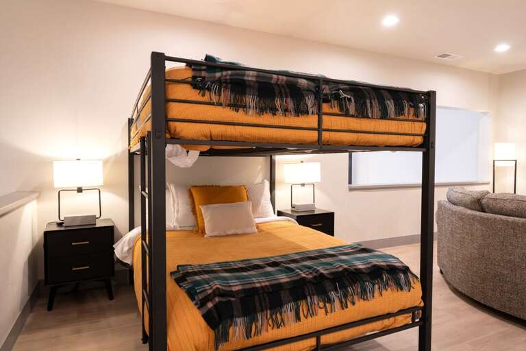 Queen over queen bunk beds in entertainment area | Upper Level