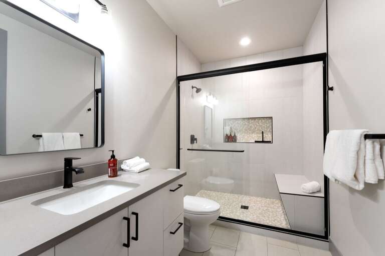 Shared bathroom with walk-in shower. | Upper Level