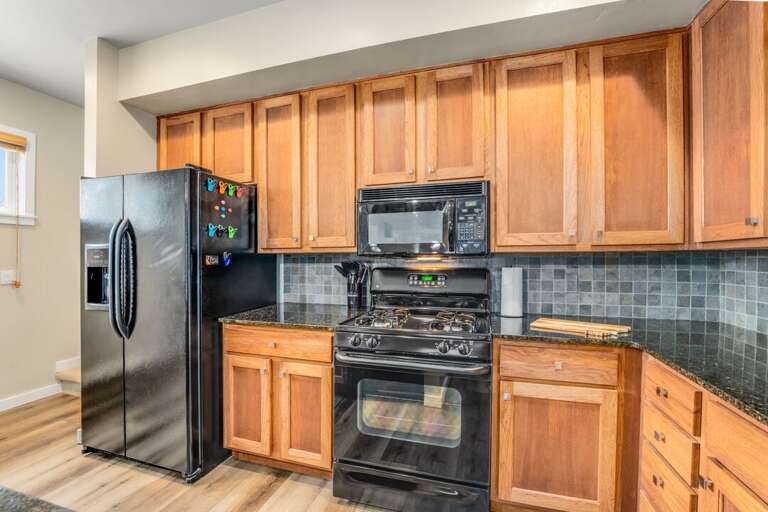 Plenty of cabinet space and lighting throughout the kitchen. | Main Level