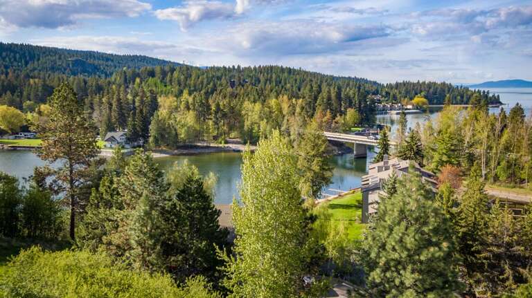 Scenic Forested Landscape With River And Bridge