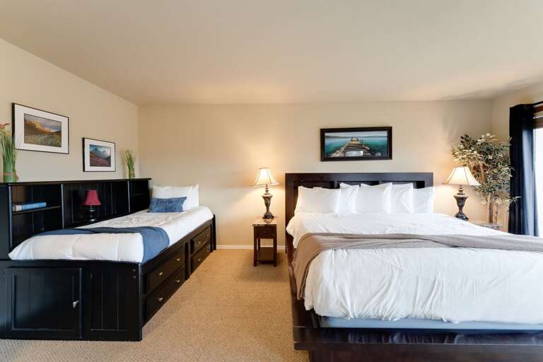 Primary bedroom with a king and twin bed. | Main Level