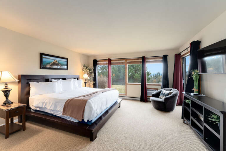 Primary bedroom with large windows. | Main Level