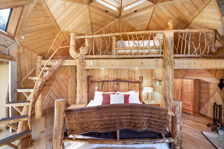 This room is finished with logs and branches giving the feel of a secluded cabin | Main Level