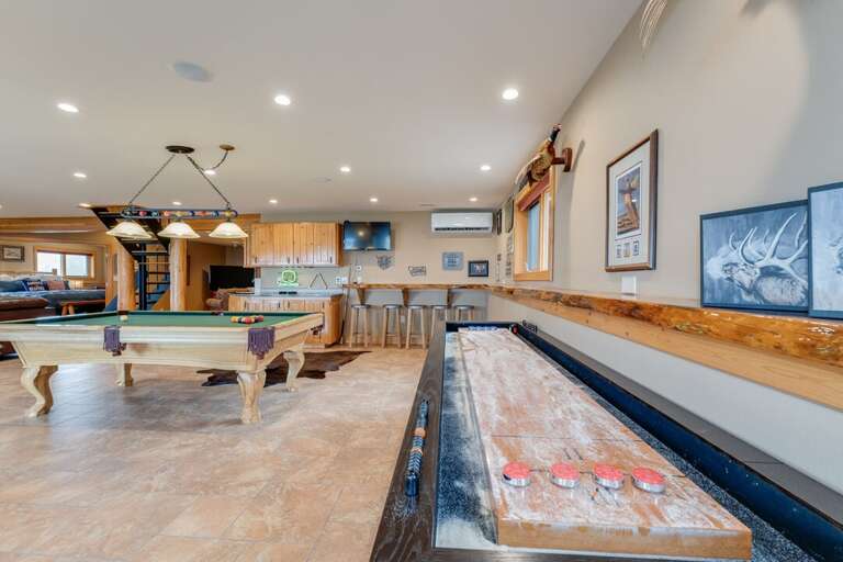 Shuffle board located near pool table in game area | Lower Level