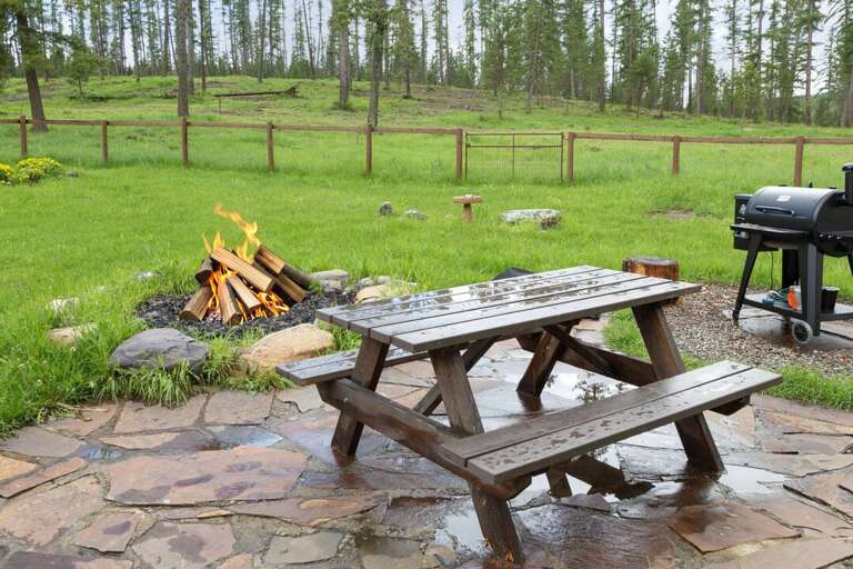 Outdoor seating area next to fire pit | Exterior