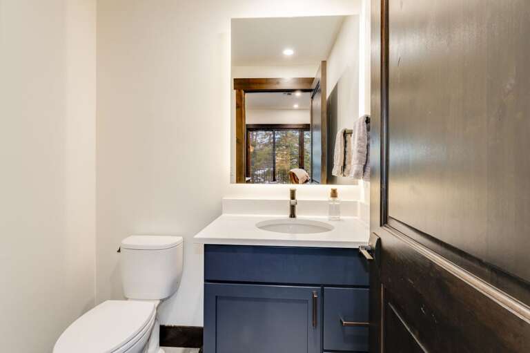 Half bath off the kitchen and living room. | Main Level