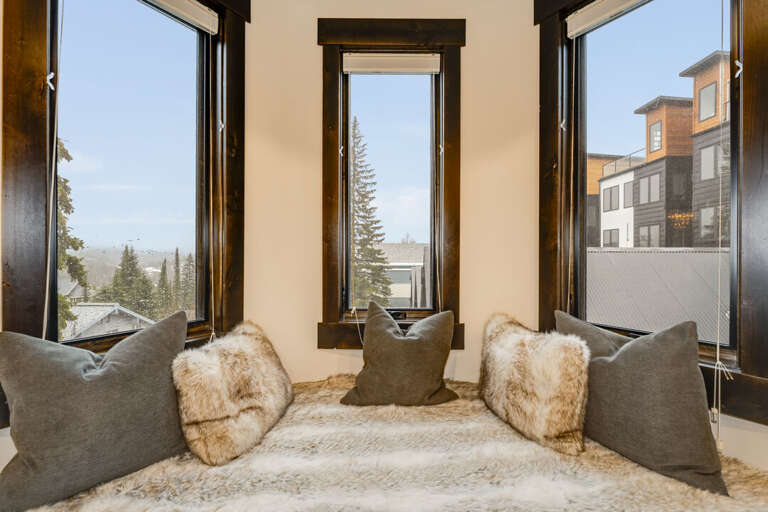 Cozy up and enjoy the views. | Main Level