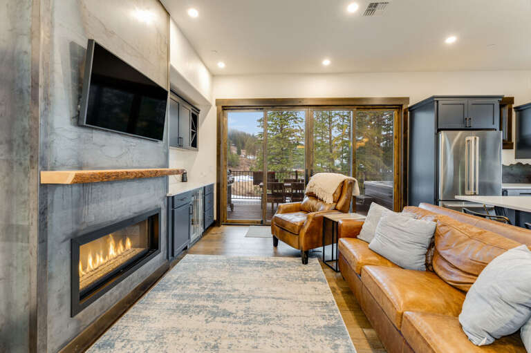 Living room with gas fireplace and TV. | Main Level
