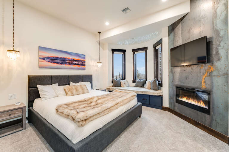 Primary with window nook, TV, and fireplace. | Main Level