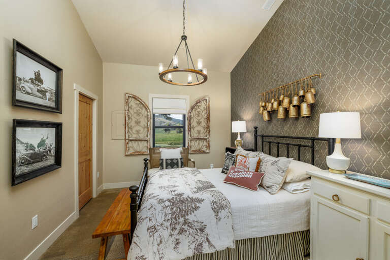 Elegant bedroom with rustic accents and decorative wall details I Main Level