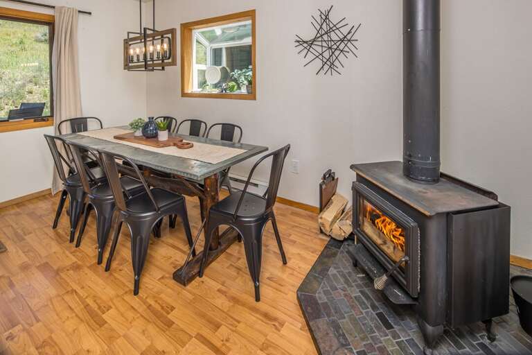 Enjoy a meal next to the wood stove with seating for 8 | Main Level