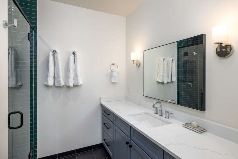 Modern tiled shower with sleek vanity | Upper Level