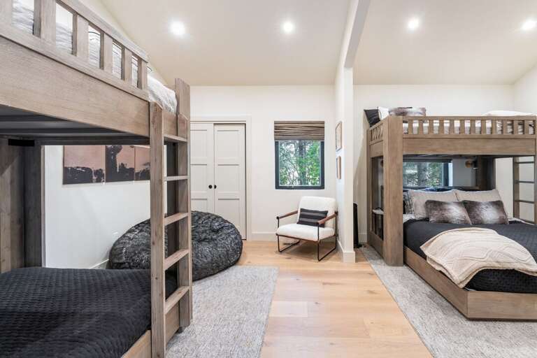 Large bedroom with two bunk beds and loft area | Interior