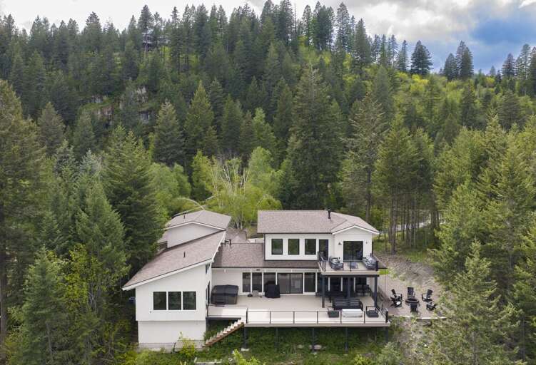 View of the back of the house with deck and fire pit area | Exterior