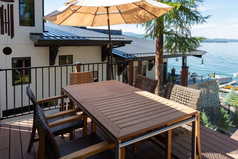 Gather around the deck table to enjoy your favorite BBQ meal with a lake view I Upper Level