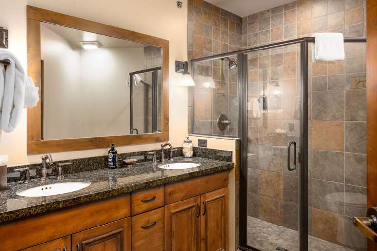 Dual vanity with walk-in shower in the secondary bedroom | Main Level