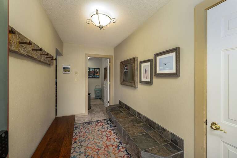 Two benches in the entry way making the perfect place to shed snow gear | Main Level