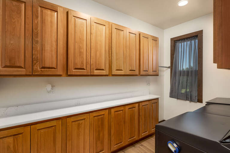 Large laundry room with washer and 
2 dyers | Upper Level