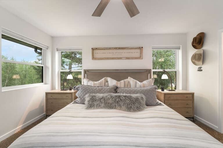 Plush pillows and big windows framing the treetops I Upper Level