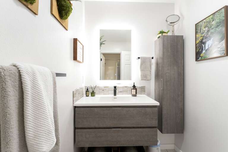 Simple and modern, with a mirror that lights up the room I Upper Level