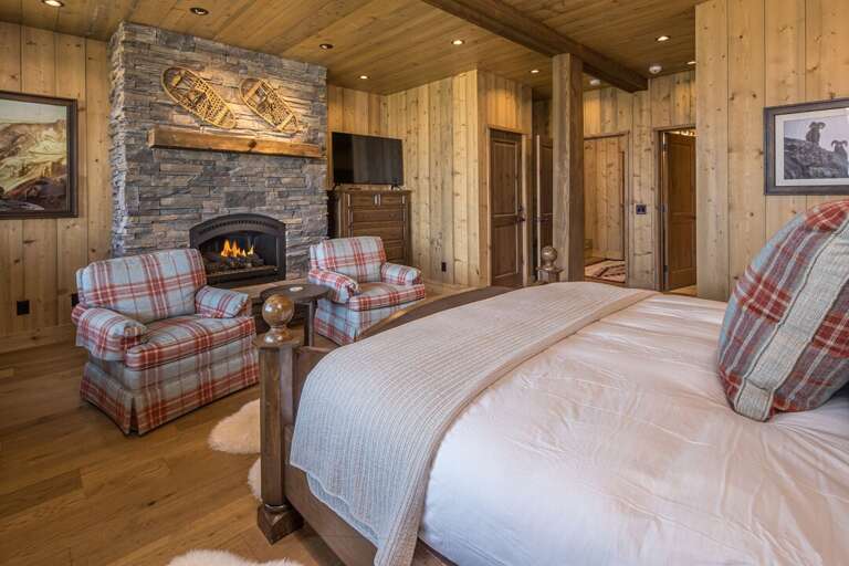 Master suite with stone fireplace and sitting area | Lower Level