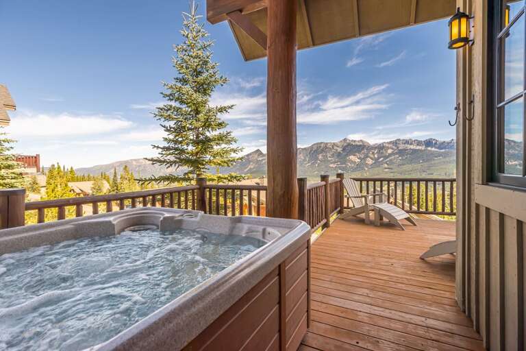 Soaking in the hot tub with mountain views | Exterior