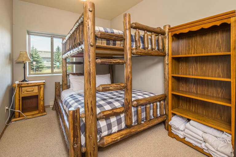Rustic log bunk beds with plaid bedding | Main Level
