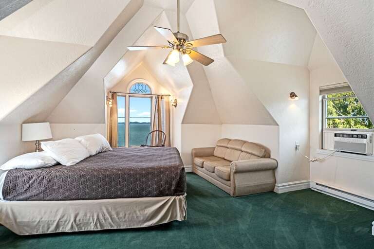 King bed with lake views. | Third Level